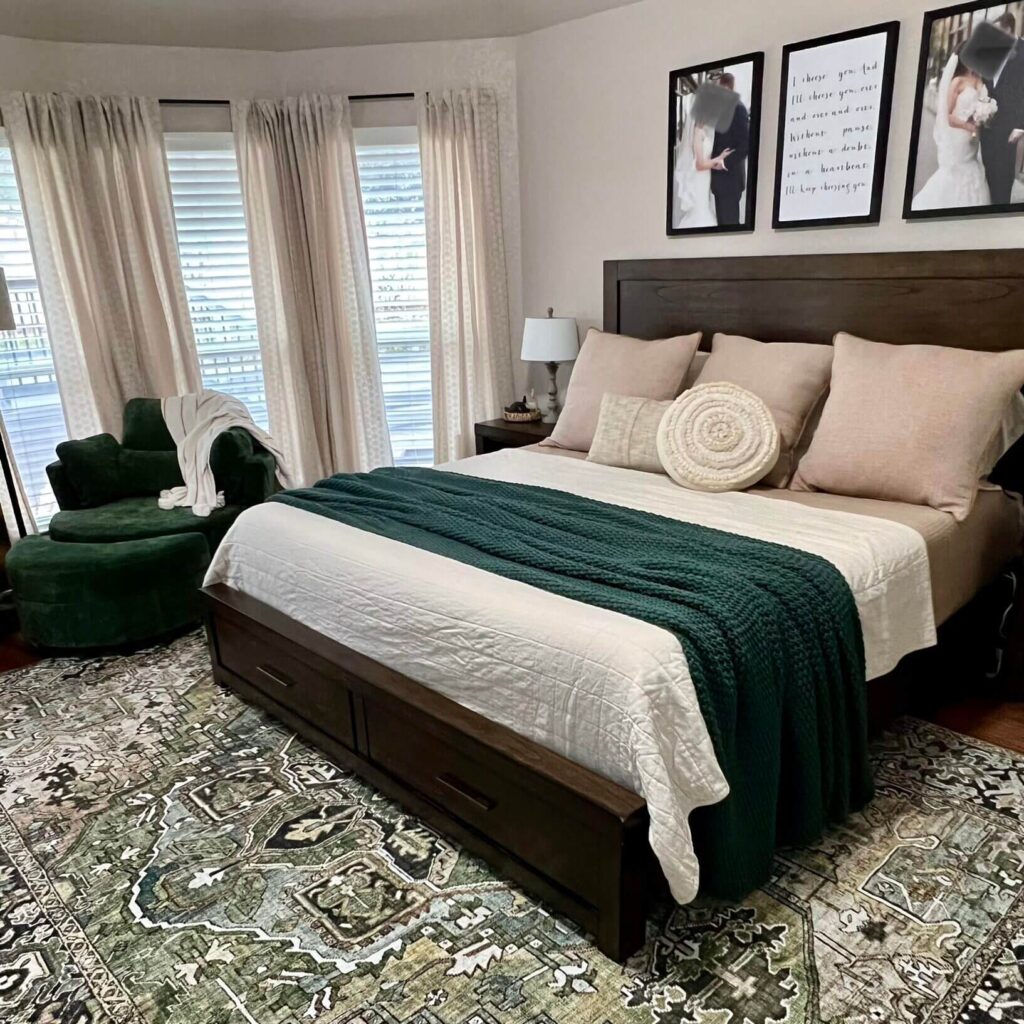 An inviting bedroom with a large bed featuring white and dark green bedding
