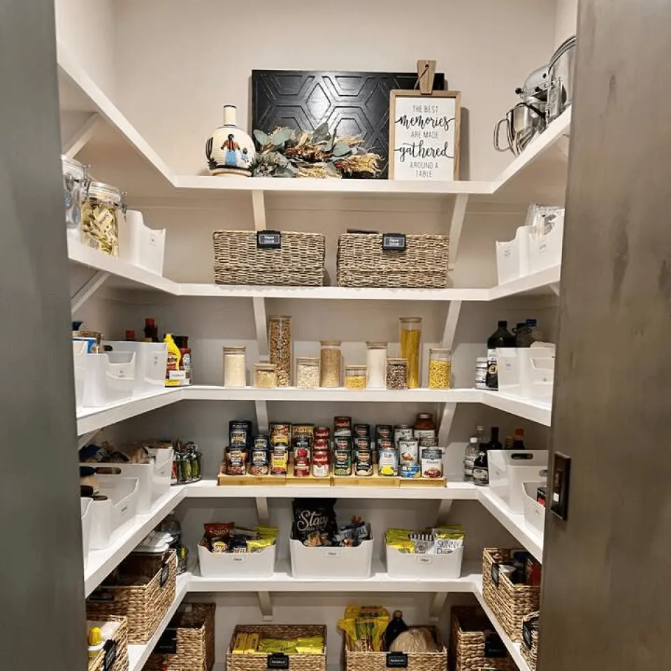 Organized pantry shelves with labeled baskets, jars, and boxes of food items.