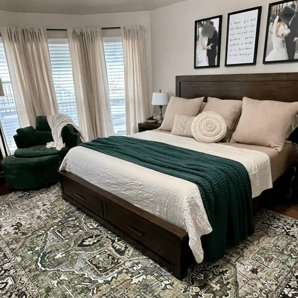 A cozy bedroom with a large bed covered in a white and green blanket