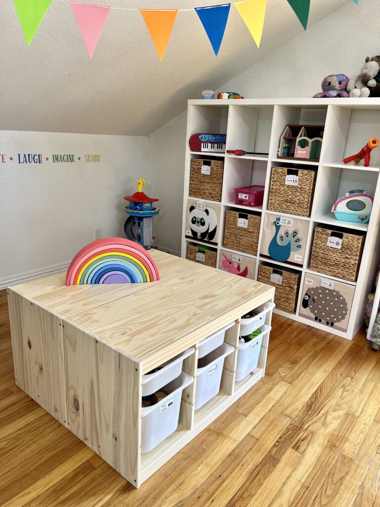 A bright and colorful child’s playroom with a wooden table