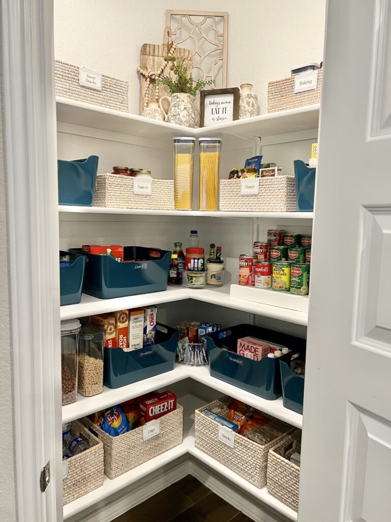 A well-organized corner pantry with white shelves